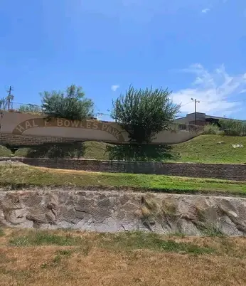 Sloped yard stepped into grassy terraces with stone walls